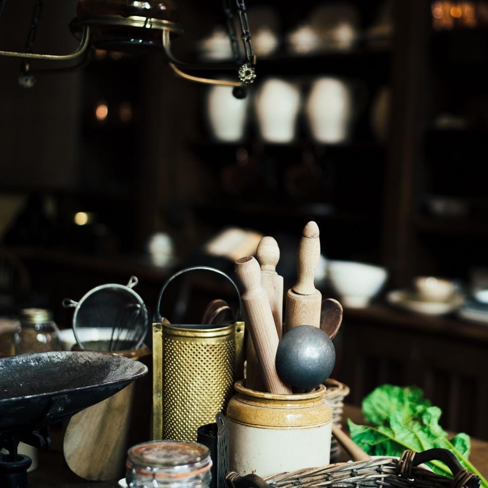 Colorful kitchen gadgets and utensils laid out on a counter